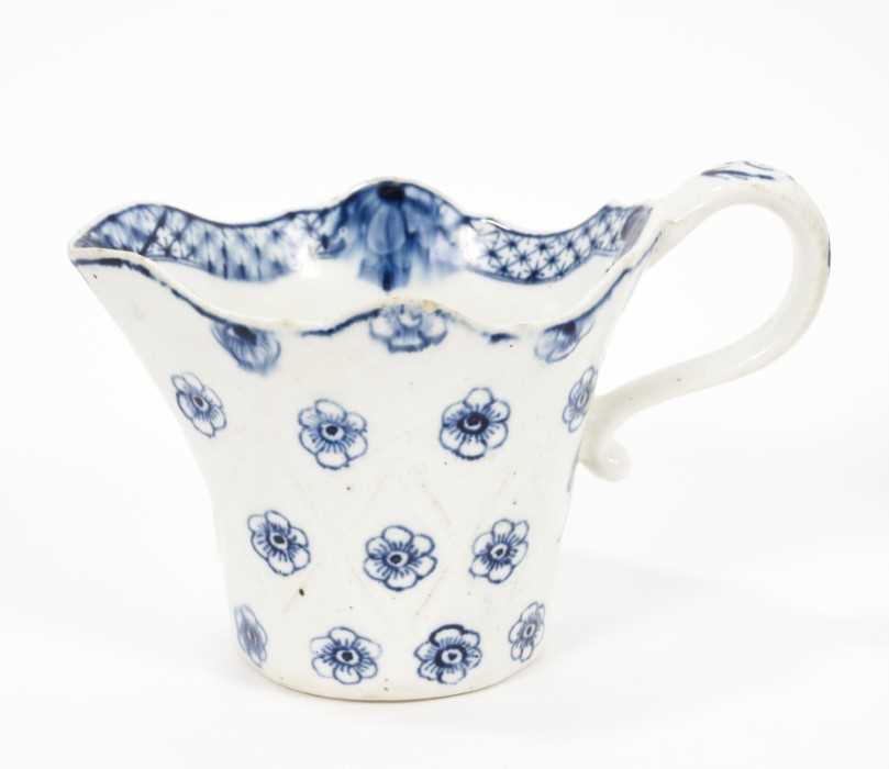 Lot 80 - A Derby blue and white jug, circa 1770, bucket shaped with unusual lozenge moulding, painted with flowers, 8.5cm high