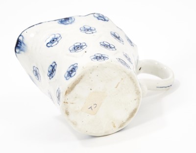 Lot 80 - A Derby blue and white jug, circa 1770, bucket shaped with unusual lozenge moulding, painted with flowers, 8.5cm high