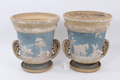 Lot 90 - Large pair of 19th century jasperware urns, probably Wedgwood, decorated with figural scenes on a two-tone light blue and buff ground, 29.5cm high