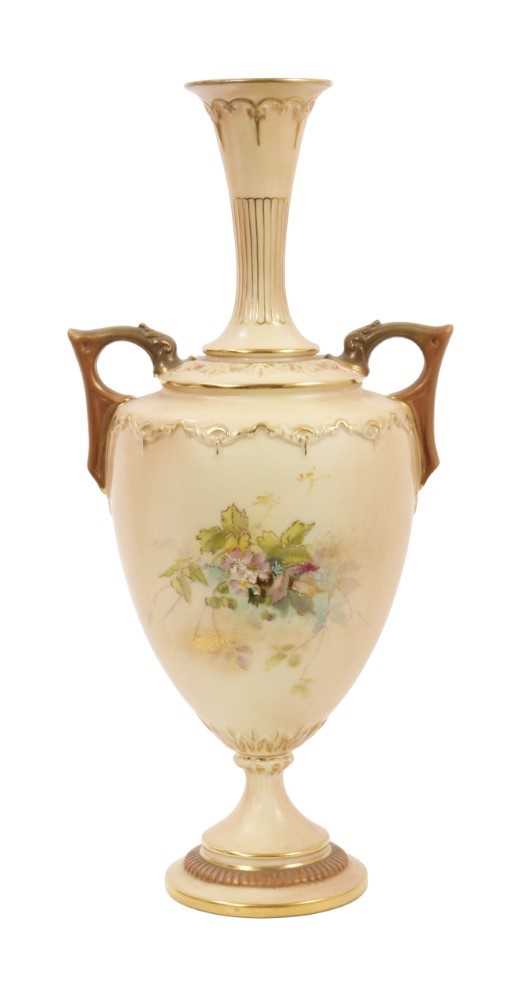 Lot 93 - A Royal Worcester twin-handled blush ivory vase, decorated with fruits and spiders, date code for 1898, 30cm high