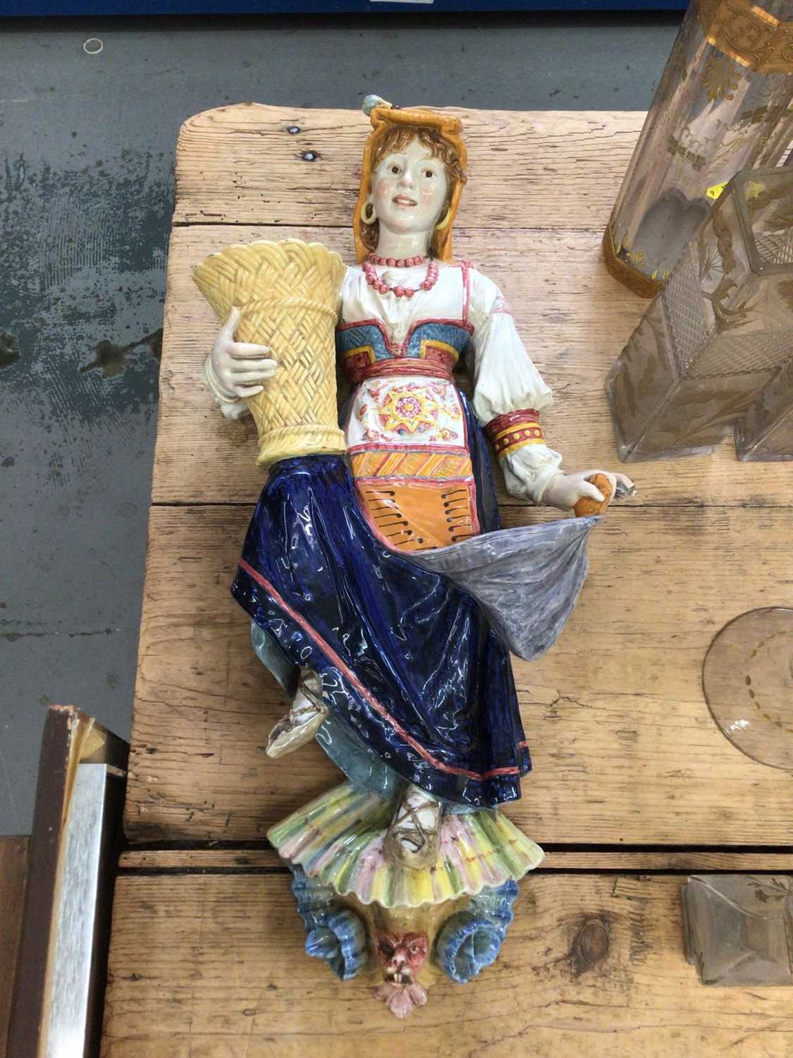 Lot 34 - Continental majolica figural wall pocket, in the form of a young girl in traditional dress