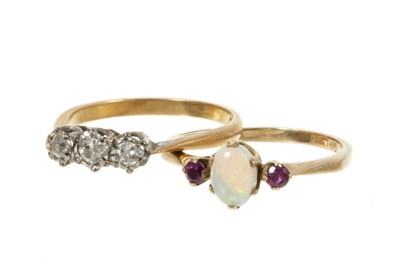 Lot 461 - Diamond three stone ring and an opal and garnet three stone ring (2)