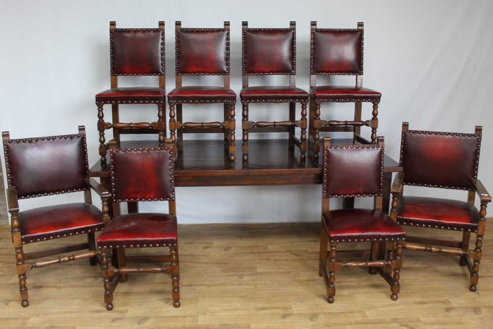 Lot 41 - Oak dining table and a set of 8 oak dining chairs with red leather upholstery