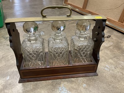 Lot 250 - Edwardian tantalus with three cut glass decanters