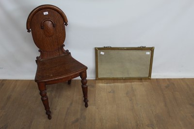 Lot 1059 - Victorian oak hall chair together with a bevelled wall mirror in brass frame (2)