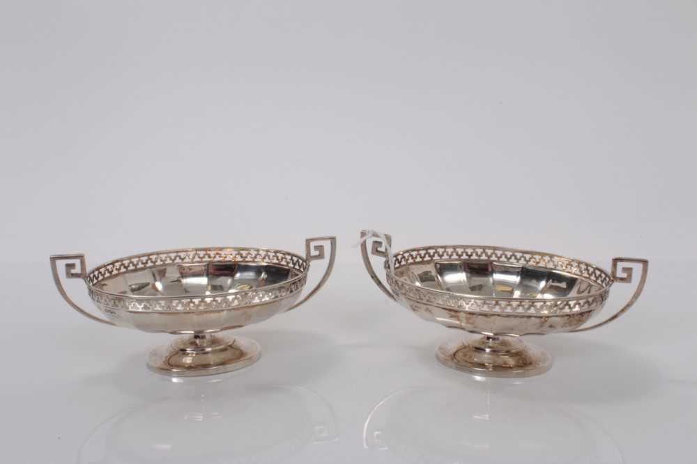 Lot 4 - Pair George V silver bon bon dishes of oval from with pierced border and Greek key handles raised on oval pedestal foot, (Sheffield 1926), maker Roberts & Belk, marked to base RD 609015, 14.8cm wid...