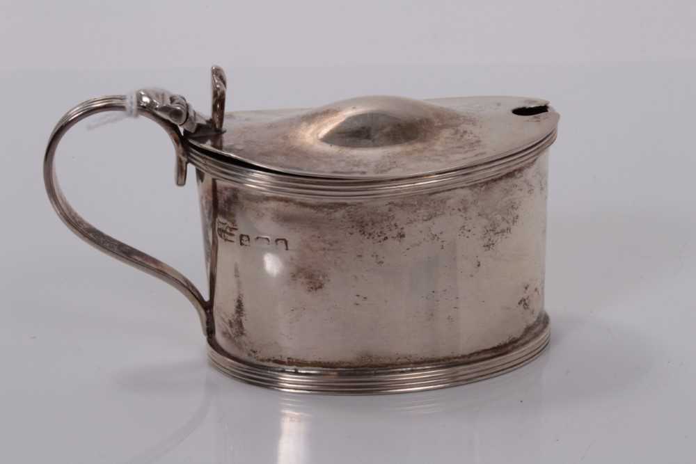 Lot 9 - George V silver mustard pot of oval form with receded borders and blue glass liner, (Birmingham 1917), maker S Blanckensee & Son Ltd, 9.5cm wide, (2.6oz)