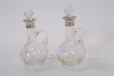 Lot 13 - Pair George V silver mounted cut glass bottles, (London 1929), maker Henry Hobson & Sons, each 17cm high