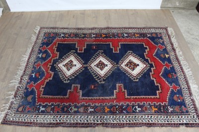 Lot 1096 - Eastern rug with geometric decoration and three central medallions on red, blue and cream ground, 79" x 60.5"