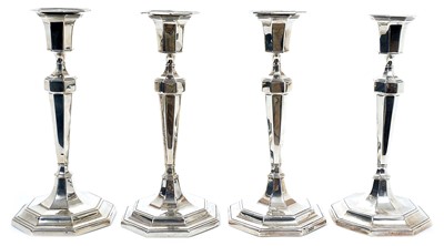 Lot 253 - Pair 1920s silver candlesticks of tapering octagonal form, with separate sconces