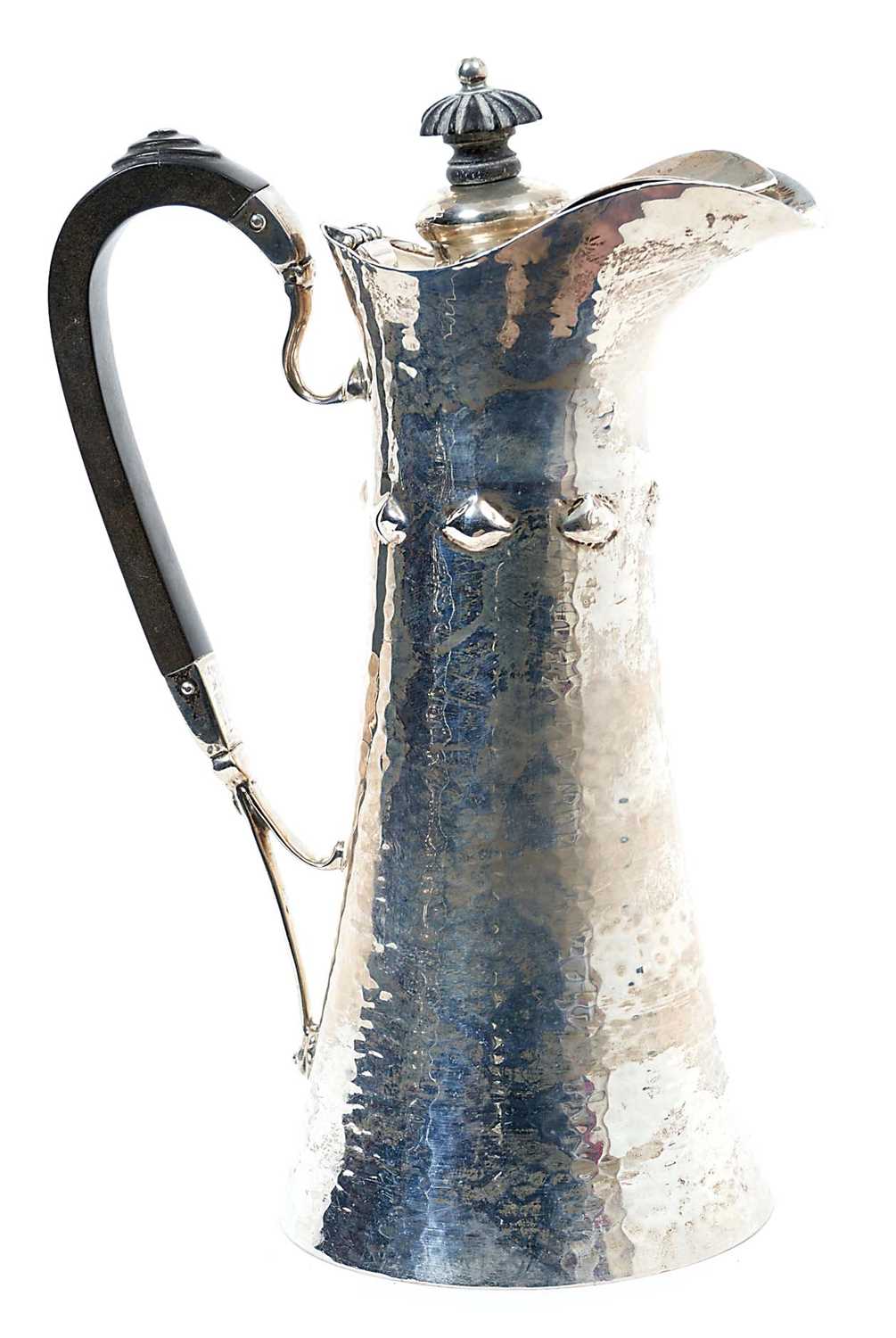 Lot 254 - Edwardian silver water jug of tapering form, with raised decoration and spot hammered finish