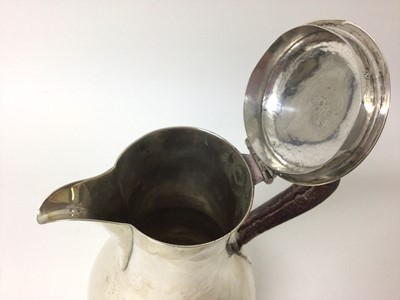 Lot 255 - George III silver jug of baluster form, with hinged cover and leather covered handle, on a circular base (London 1768) Philip Norman. All at approximately 13ozs. 23.5cm overall height.