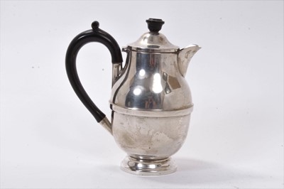 Lot 256 - 1930s silver hot water jug of compressed baluster form, with hinged domed cover and ebony loop handle