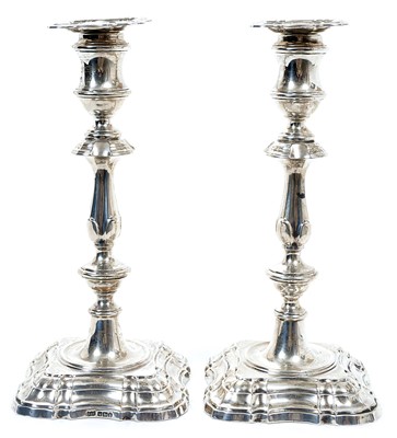 Lot 257 - Pair George V silver candlesticks in the Georgian style, with decorative baluster stems