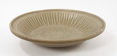 Lot 102 - Chinese celadon dish, Yuan dynasty, from the Java shipwreck, with ribbed moulding and central floral medallion, 31.5cm diameter