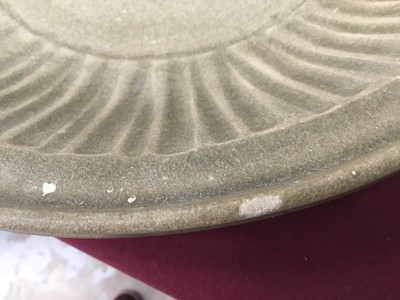 Lot 102 - Chinese celadon dish, Yuan dynasty, from the Java shipwreck, with ribbed moulding and central floral medallion, 31.5cm diameter