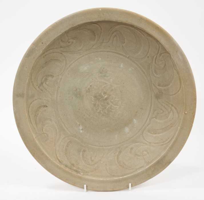 Lot 103 - Chinese celadon dish, Yuan dynasty, from the Java shipwreck, with incised floral decoration, 32cm diameter
