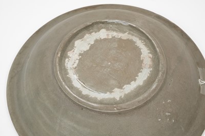 Lot 104 - Chinese celadon dish, Yuan dynasty, from the Java shipwreck, with floral moulding, 31cm diameter, together with a book on the Hatcher cargo (2)
