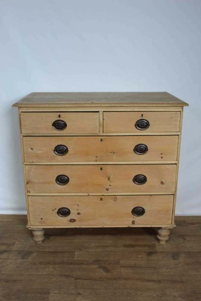 Lot 70 - Pine chest of drawers with embossed brass handles.