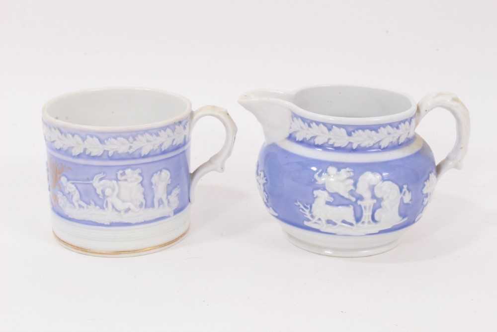 Lot 166 - A New Hall mug, with applied decoration, on a lilac ground, and dated 1819, and a similar jug