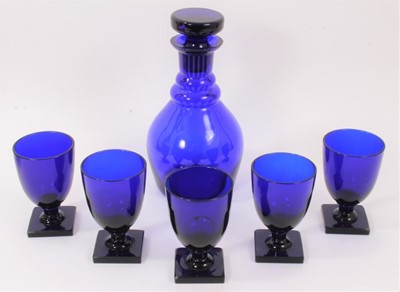 Lot 169 - A ‘Bristol’ blue tinted glass decanter and stopper and five rummers, each on square base