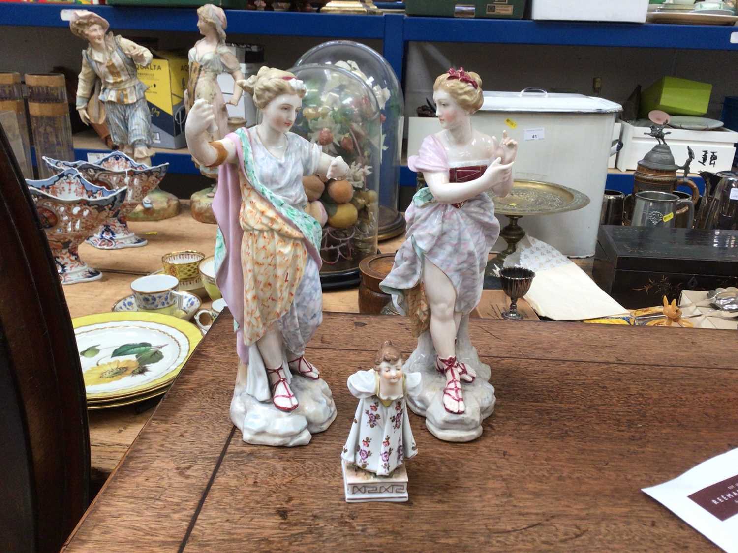 Lot 65 - A pair of late Continental porcelain figures, and a smaller figure
