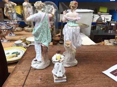 Lot 99 - A pair of late Continental porcelain figures, and a smaller figure