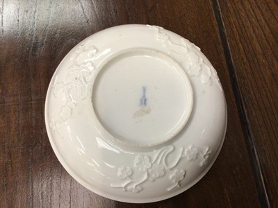 Lot 261 - 18th century Meissen blanc de chine saucer, relief decorated with prunus blossom, crossed swords mark to base, 13.5cm diameter