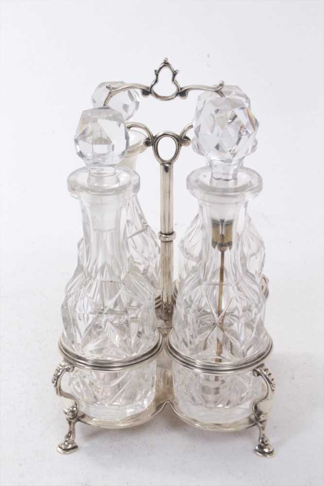 Lot 264 - Victorian four bottle silver cruet frame, with quatrefoil base and central carrying handle
