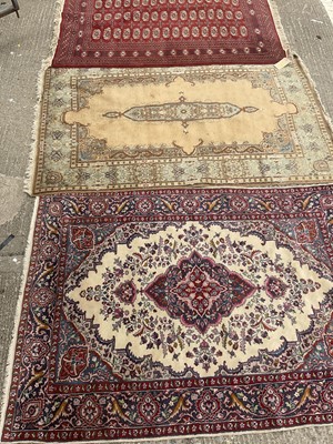 Lot 1205 - Bokhara carpet 180cm x 128cm, Kashmir carpet 190cm 125cm and a Kashmir carpet 180cm x 130cm (3)