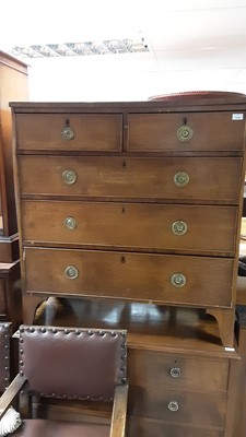 Lot 1114 - Georgian oak chest of two short and three long drawers with brass ring handles, on bracket feet