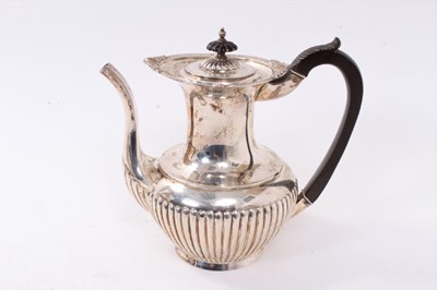 Lot 272 - Early George V silver teapot of fluted baluster form, with flared rim, ebony handle