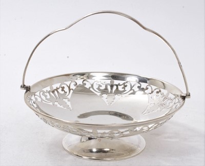 Lot 275 - 1920s silver swing handled dish, with pierced decoration, on a compressed pedestal foot