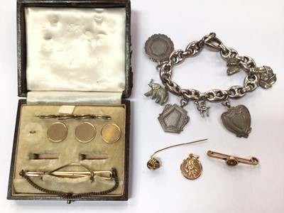 Lot 930 - Three 9ct gold dress studs in fitted case, 9ct gold knot stickpin, 9ct gold bar brooch, 9ct gold St. Christopher pendant and silver charm bracelet with silver fobs