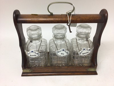 Lot 2424 - Edwardian three bottle oak tantalus