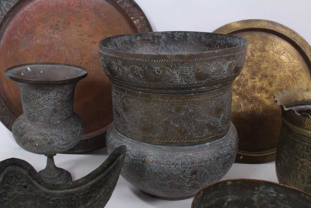 Lot 811 - Good group of Indian and Middle Eastern metalwares, circa 19th century, including vases and bowls, with engraved and relief-form decoration