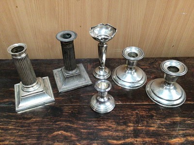 Lot 959 - Two pairs of silver candlesticks, one other small silver candlestick and silver spill vase