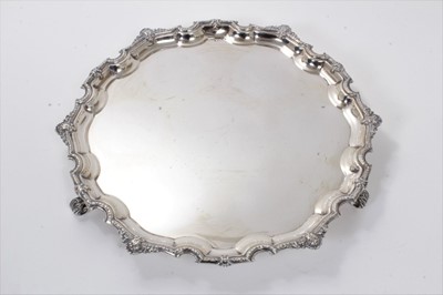 Lot 294 - 1930s silver salver of hexagonal form, with stylized shell and floral border, on four scroll feet