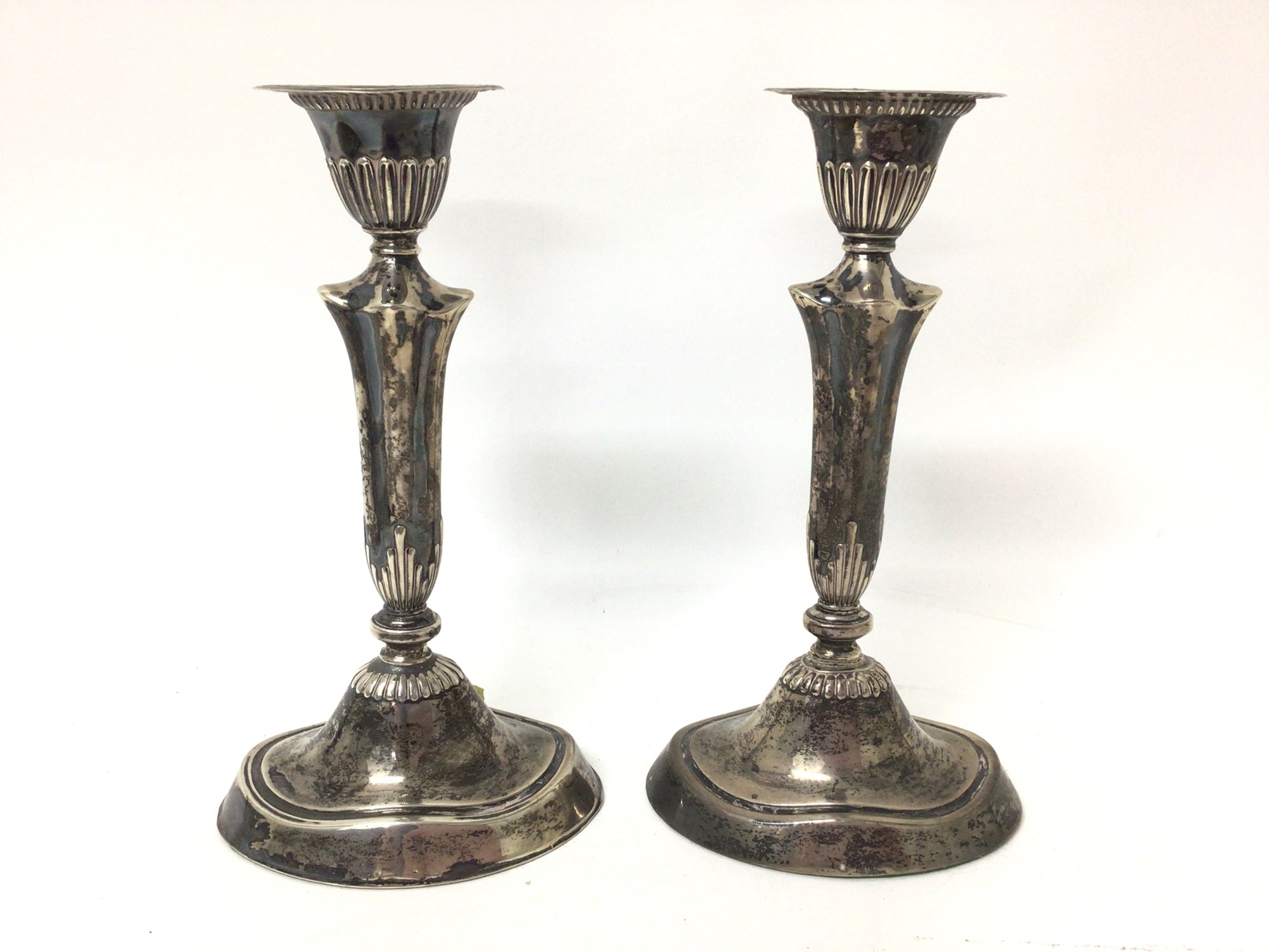 Lot 64 Pair of Edwardian silver candlesticks (London