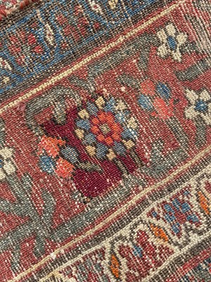 Lot 1477 - Antique Hamadan runner with all over floral motif in meander boarders on red and blue ground. 500cm long x 102cm wide