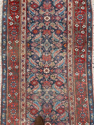Lot 1477 - Antique Hamadan runner with all over floral motif in meander boarders on red and blue ground. 500cm long x 102cm wide