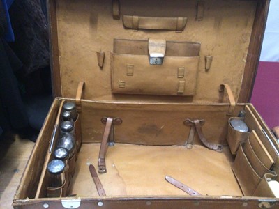 Lot 2089 - Vintage brown leather suitcase with fitted interior containing silver topped glass jars and other travelling items