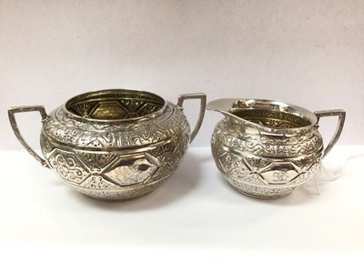 Lot 969 - Victorian silver bachelor's cream jug and sugar basin with Anglo-Indian embossed decoration and engraved family crest (Sheffield 1870)