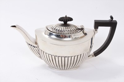 Lot 316 - 1920s silver teapot of half fluted form with hinged domed cover and angular Ebony handle