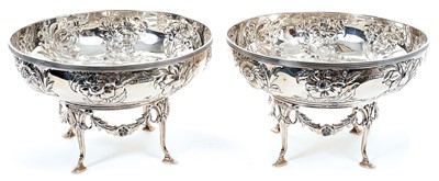 Lot 318 - Pair Edwardian silver bowls with embossed floral decoration, with separate matching stands