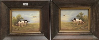 Lot 952 - Pair of early 20th century Crown Devon hand painted pottery wall plaques depicting spaniels chasing game birds, signed R. Hinton, numbered 0929, in original oak frames. 16.5mm x 22cm.