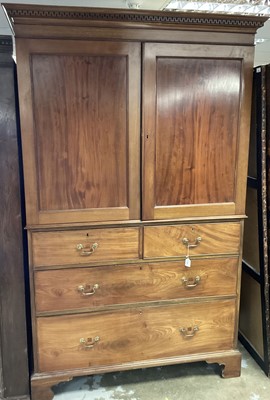 Lot 1304 - 19th century mahogany linen press with Greek key carved cornice above twin panelled doors enclosing slides, over two short and two long graduated drawers, on bracket feet