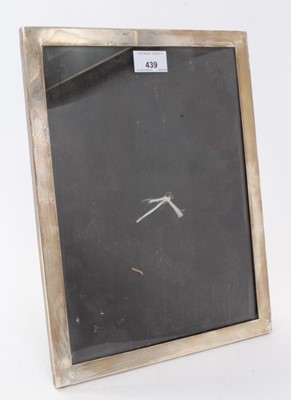 Lot 439 - George V silver photograph frame of rectangular form with easel back, (Birmingham 1921), maker Saunders & Mackenzie. 33.5 x 26cm overall.