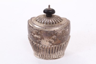 Lot 400 - George V silver tea caddy of oval form with fluted decoration, hinged domed cover, with turned wood finial (Birmingham 1912), maker William Aitken, All at approximately 4.5ozs. 12cm overall height.