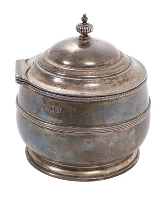 Lot 401 - George V silver tea caddy of cauldron form with central band of reeded decoration, hinged domed cover, with fluted finial, on circular foot